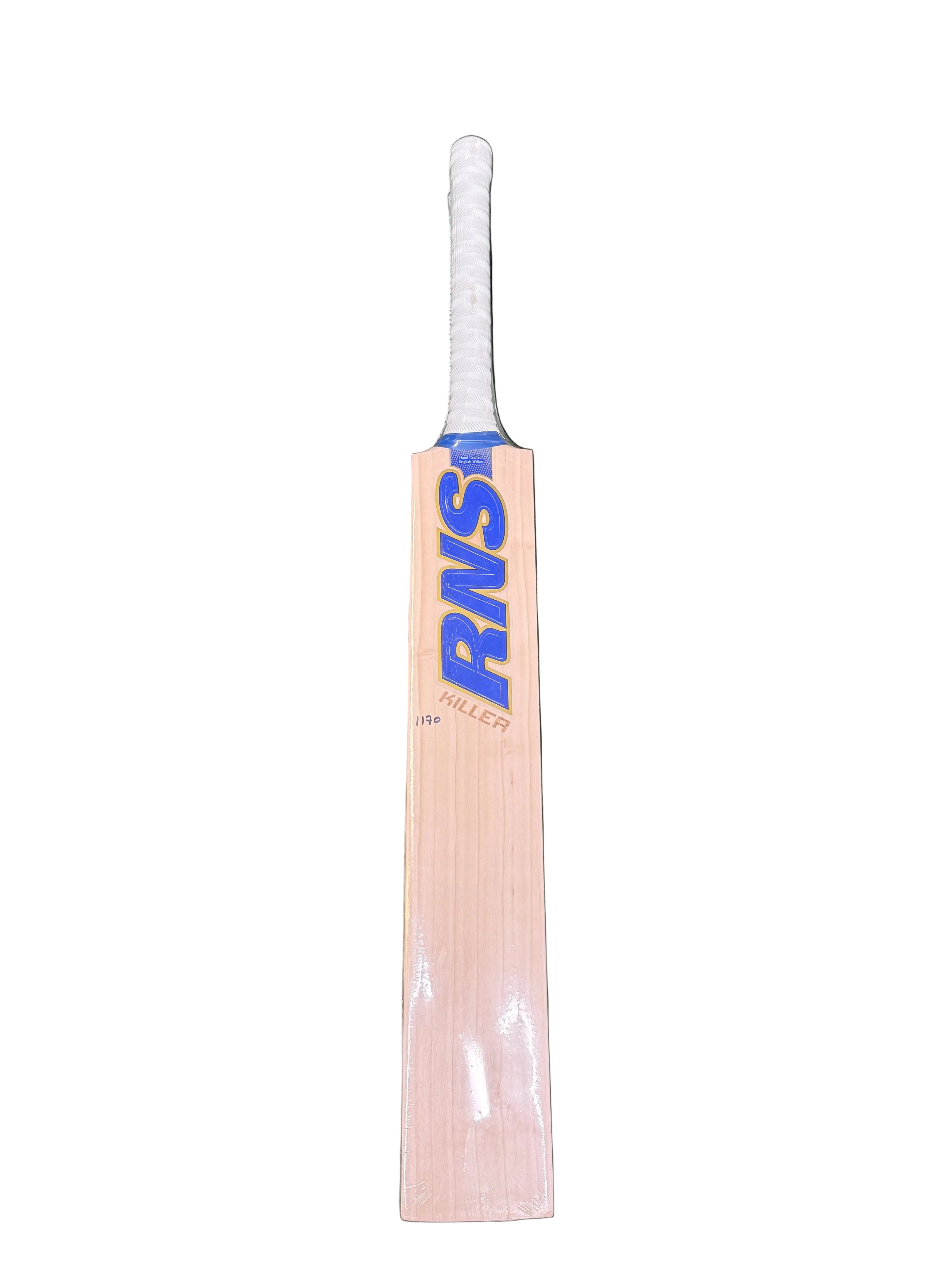 A wooden cricket bat with a white wrapped handle and blue 'RNS' branding, placed vertically on green artificial turf.