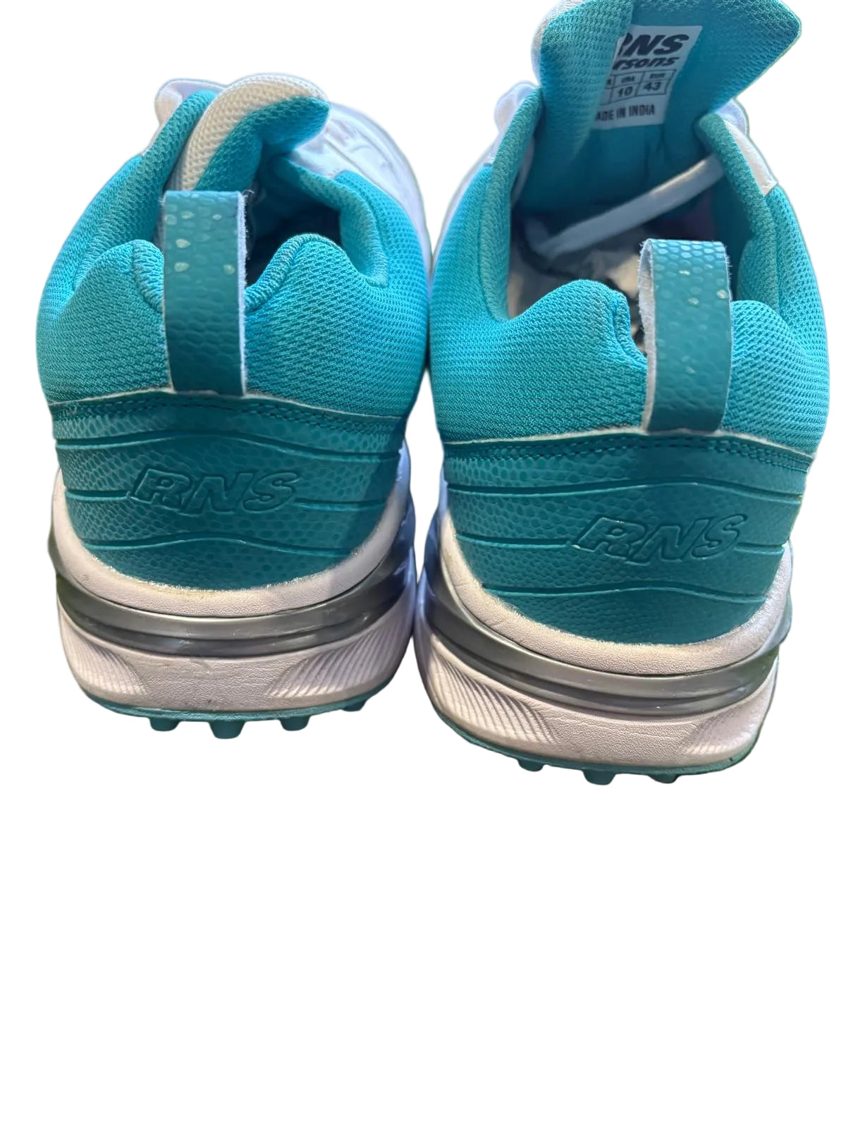 Pair of blue running shoes on grass